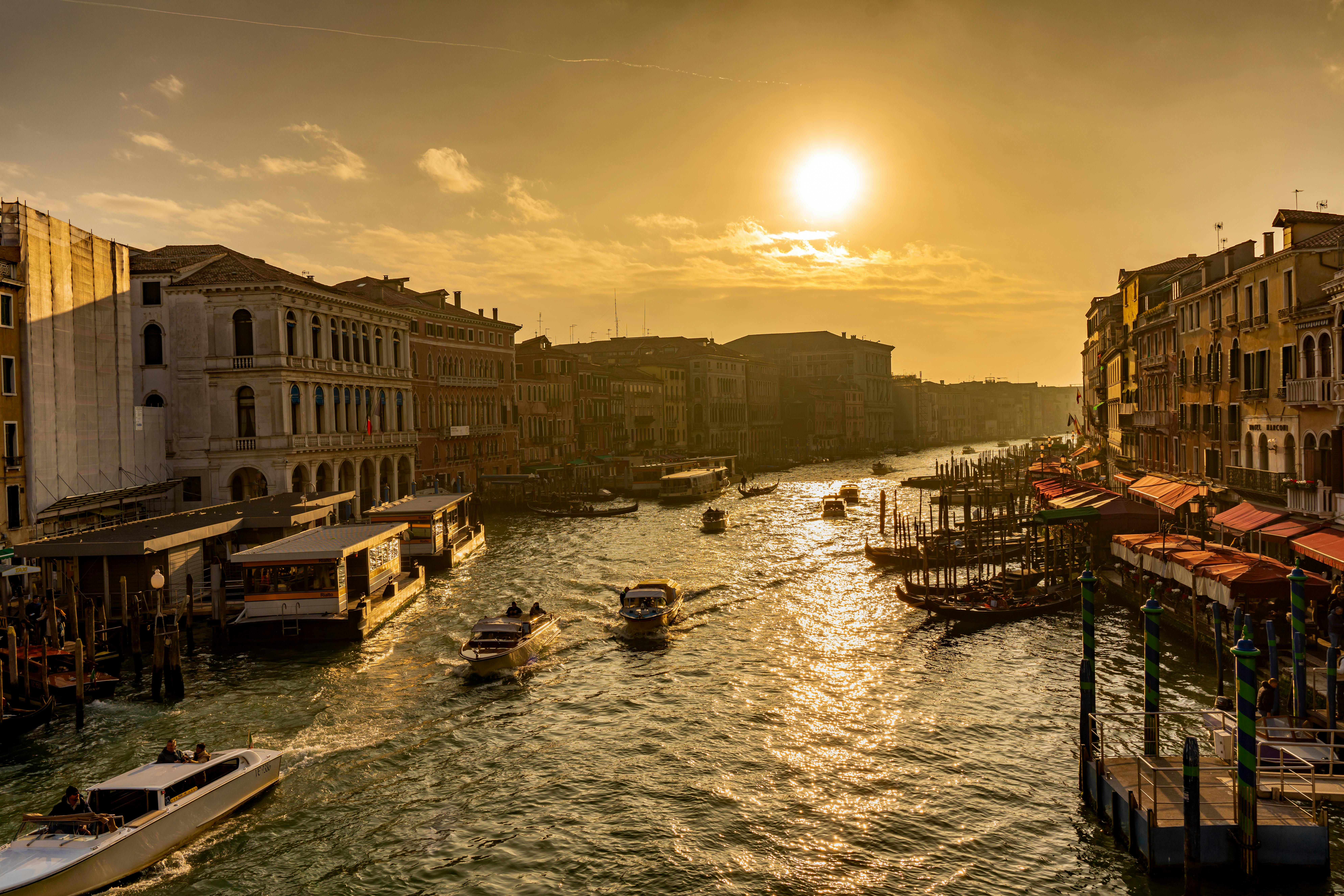Venice canal at golden hour with gondolas and domes